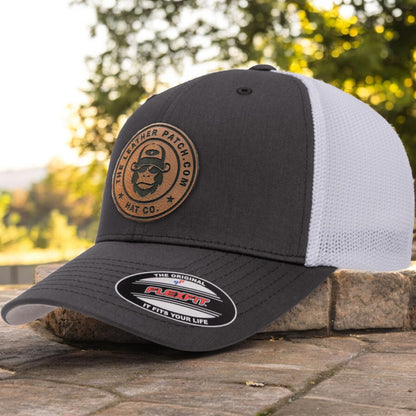 a black and white hat sitting on top of a brick wall