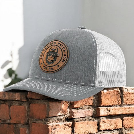 a gray and white hat sitting on top of a brick wall