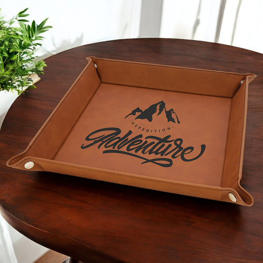 a wooden table with a brown leather tray on top of it