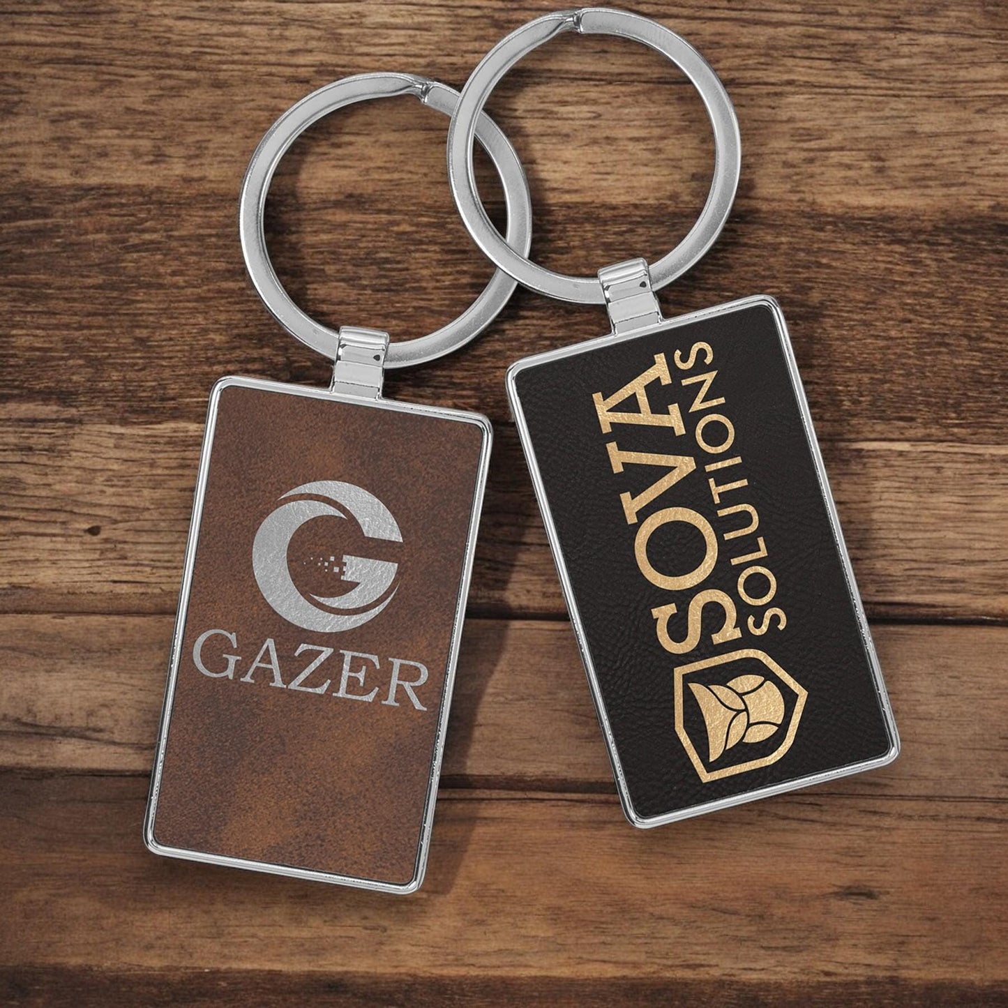 a couple of metal key chains sitting on top of a wooden table